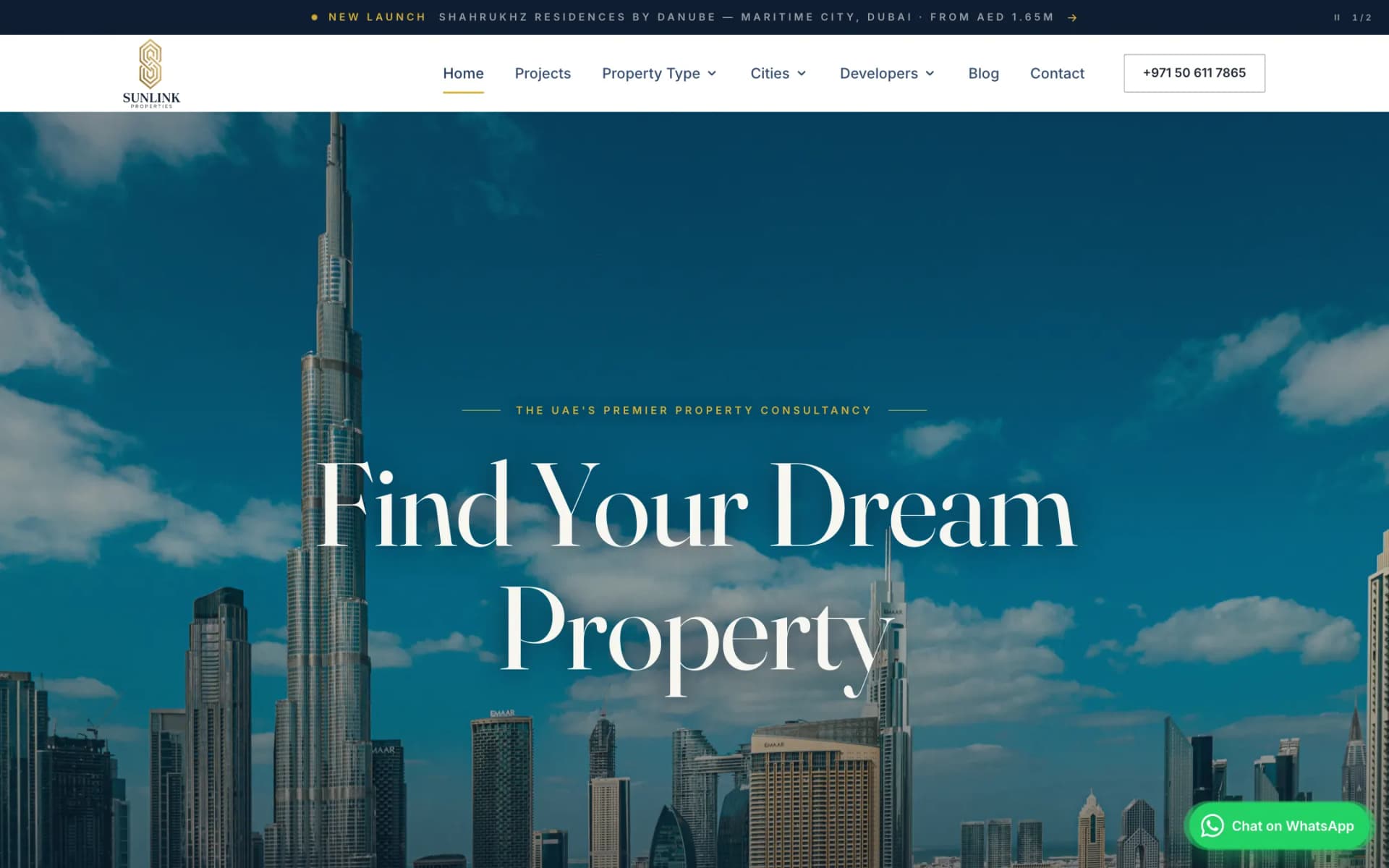 Sunlink Properties homepage hero: full-bleed Dubai skyline with the Burj Khalifa under a blue sky, the serif headline 'Find Your Dream Property' centred over it, and the white navigation bar with the Sunlink logo above